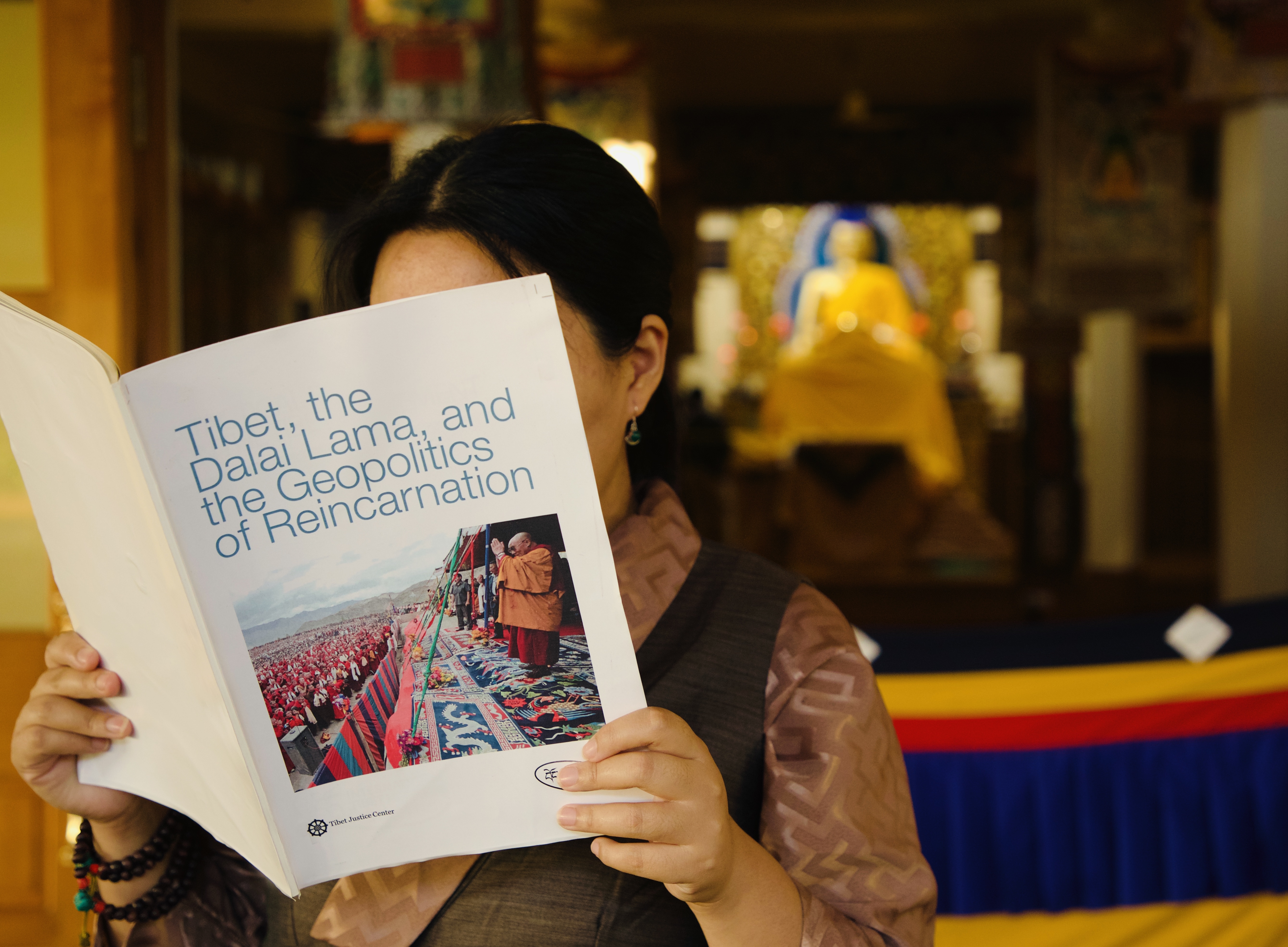 Tibetan in Dharamsala reading the report 'Tibet, the Dalai Lama and the Geopolitics of Reincarnation.'
