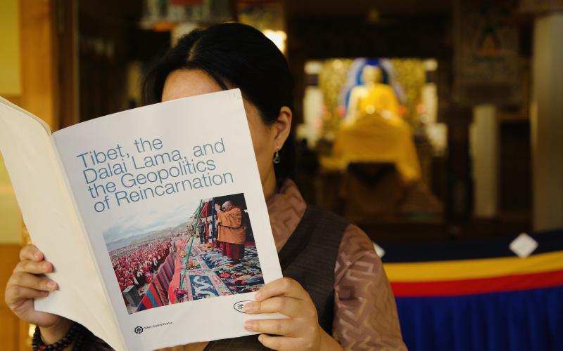 Tibetan in Dharamsala reading the report 'Tibet, the Dalai Lama and the Geopolitics of Reincarnation.'